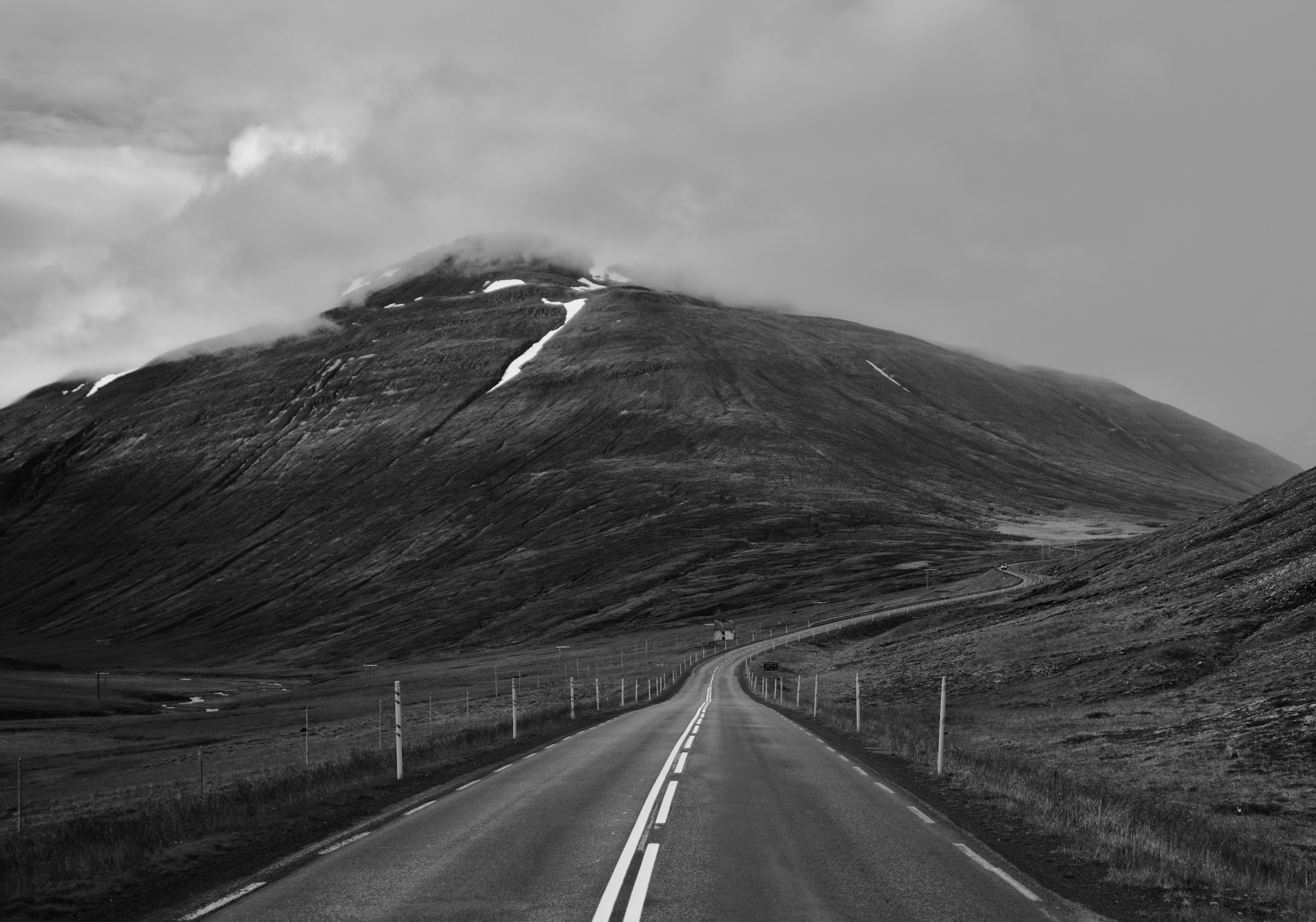 grayscale photo of road and mountain